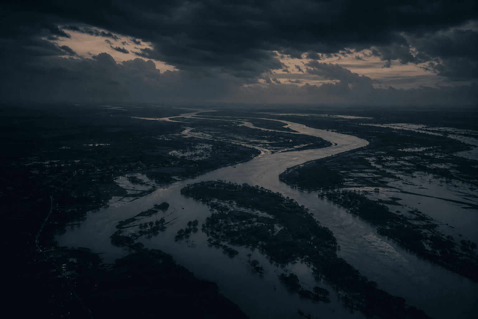 A swollen monsoon river delta at dusk in eastern India